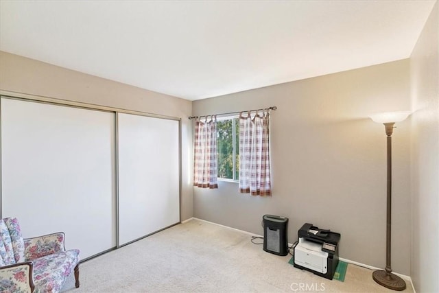 bedroom featuring light carpet and a closet