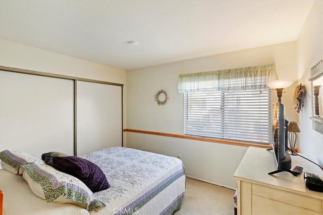 carpeted bedroom featuring a closet