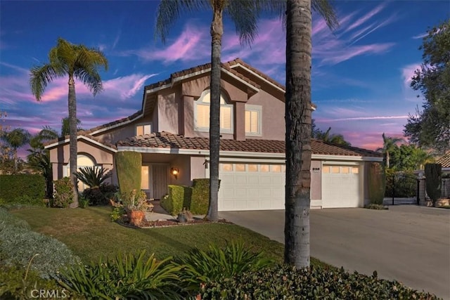 view of front of property featuring a yard and a garage