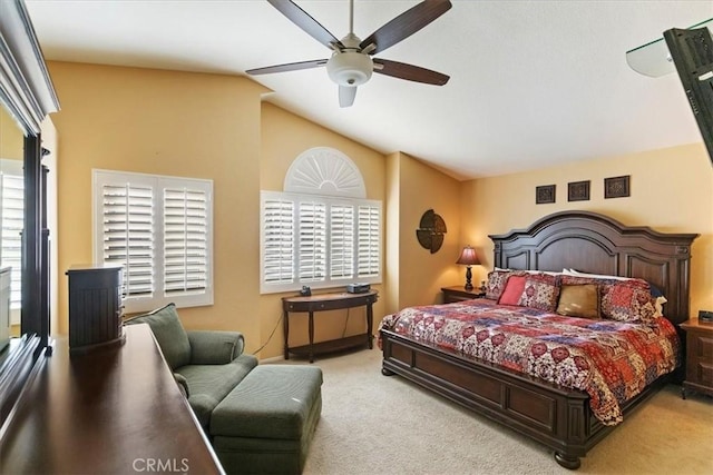 carpeted bedroom with ceiling fan and vaulted ceiling