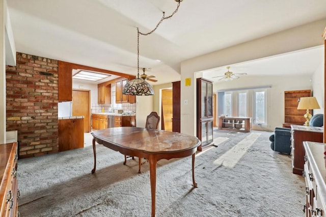 dining area with light carpet and ceiling fan