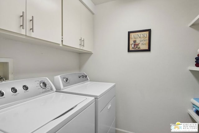 laundry area with washer and clothes dryer and cabinets