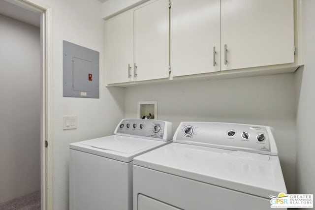 laundry room with separate washer and dryer, electric panel, and cabinets