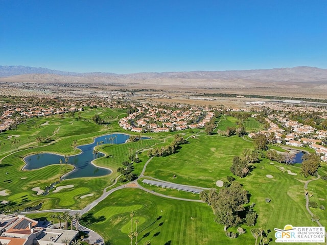 birds eye view of property with a water and mountain view