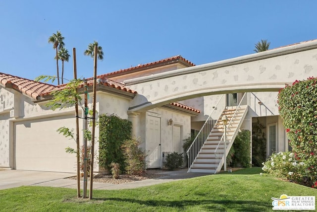 view of front of house with a garage and a front lawn