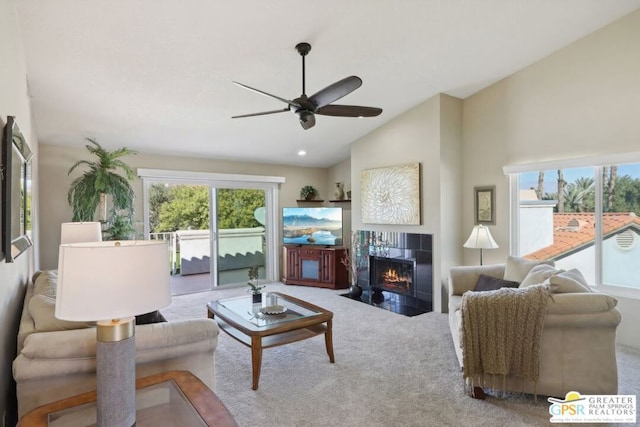 carpeted living room featuring ceiling fan, a fireplace, and high vaulted ceiling