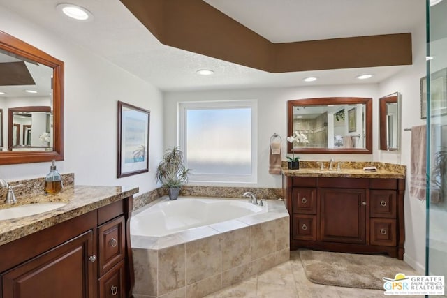 bathroom featuring tile patterned flooring, vanity, and shower with separate bathtub