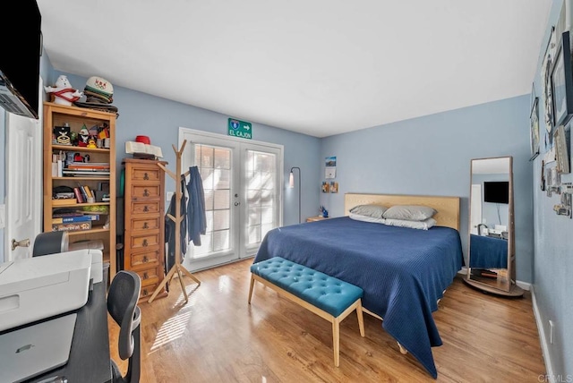 bedroom with light wood-type flooring, access to outside, and french doors