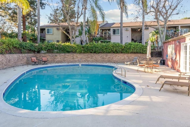 view of swimming pool featuring a patio area