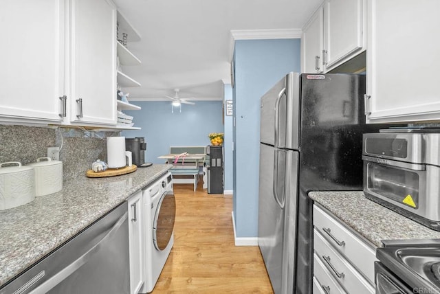 kitchen with white cabinets, washer / dryer, and stainless steel appliances