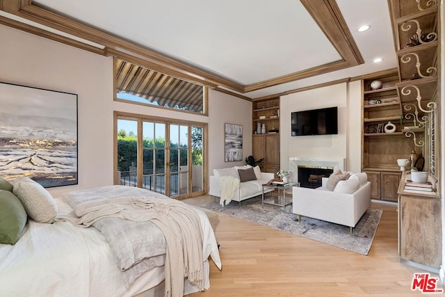 bedroom with access to exterior, crown molding, a high end fireplace, and wood-type flooring