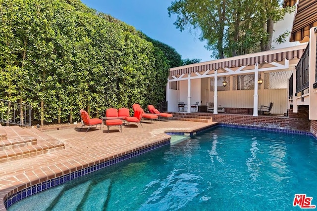 view of swimming pool featuring a patio area