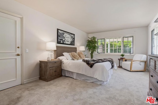 bedroom featuring light colored carpet