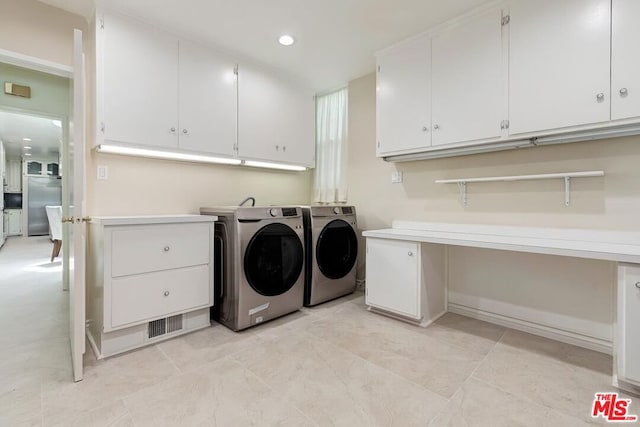 laundry area featuring cabinets and separate washer and dryer