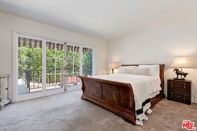 carpeted bedroom featuring multiple windows and access to exterior