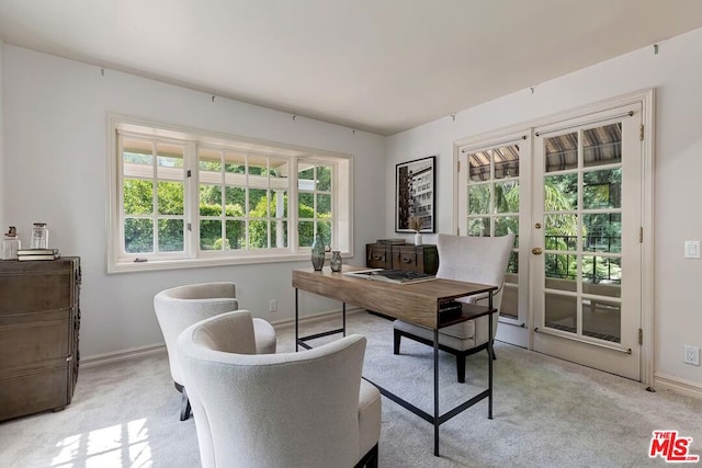 carpeted home office featuring french doors