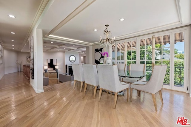 dining space with a healthy amount of sunlight, light wood-type flooring, and a chandelier