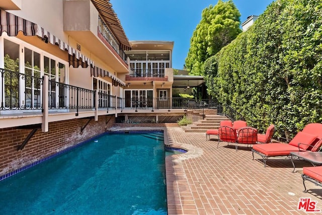 view of swimming pool featuring a patio area