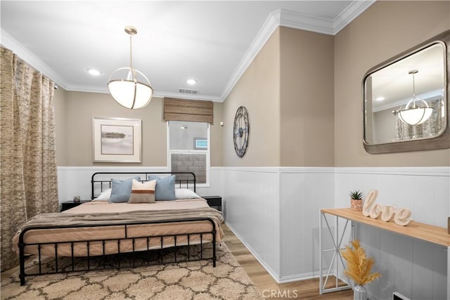 bedroom featuring light hardwood / wood-style flooring and crown molding