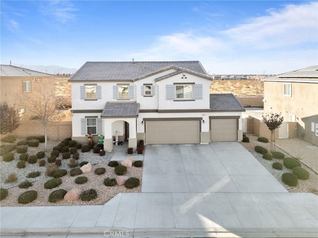 view of front of property with a mountain view and a garage