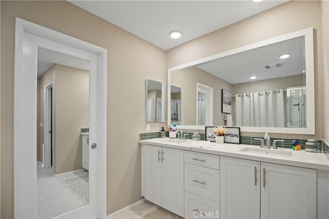 bathroom featuring tasteful backsplash and vanity