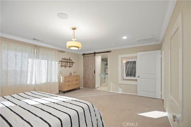 bedroom featuring ensuite bathroom, a barn door, ornamental molding, and light carpet