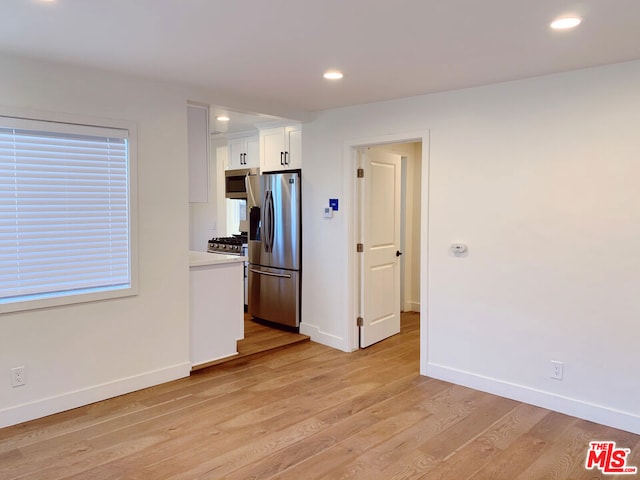 kitchen featuring white cabinetry, stainless steel appliances, and light hardwood / wood-style floors