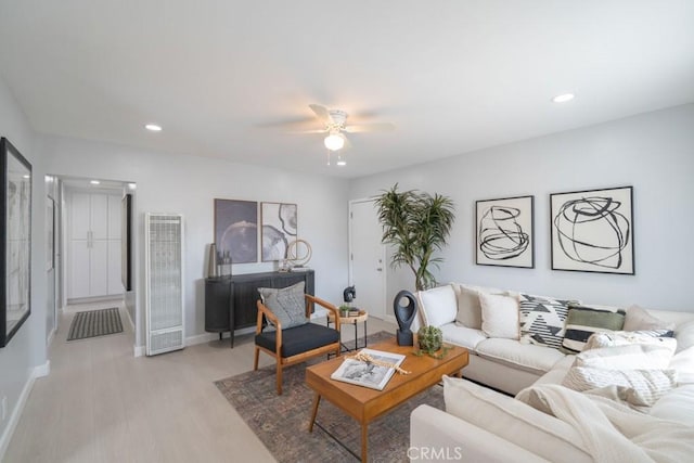 living room featuring ceiling fan and light hardwood / wood-style flooring