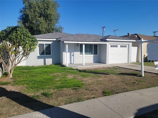 single story home featuring a front lawn and a garage