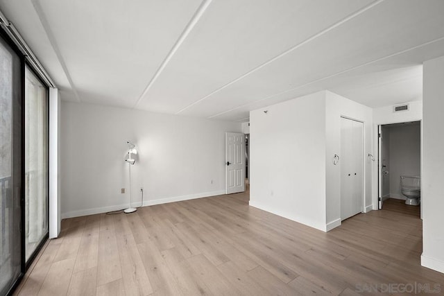 spare room with light hardwood / wood-style flooring