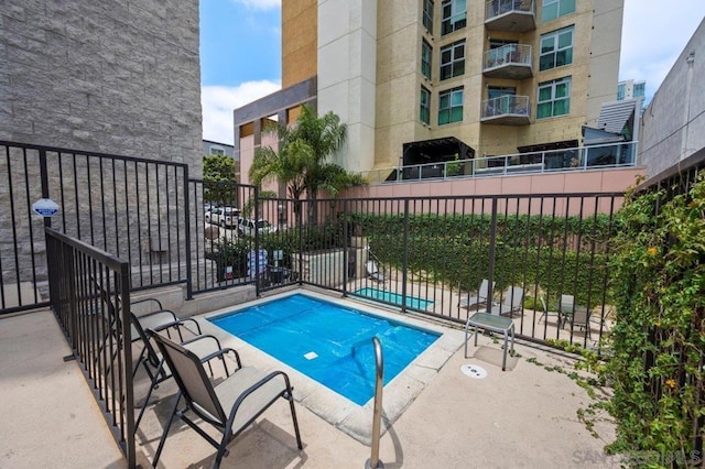 view of swimming pool featuring a patio area