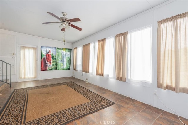 interior space with ceiling fan