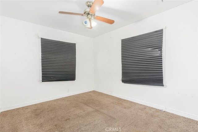 empty room featuring light carpet and ceiling fan