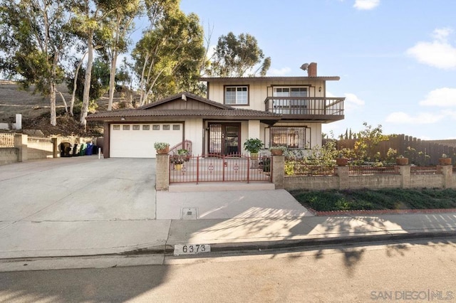 front facade with a balcony and a garage