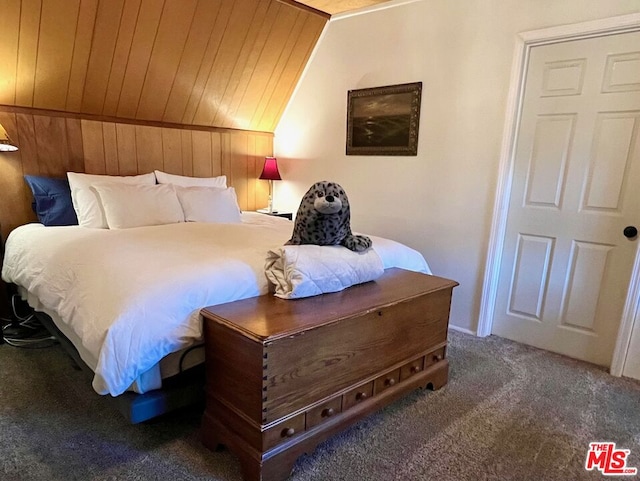 carpeted bedroom featuring vaulted ceiling, wooden walls, and wood ceiling