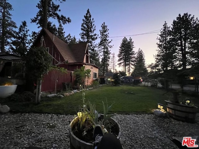 view of yard at dusk