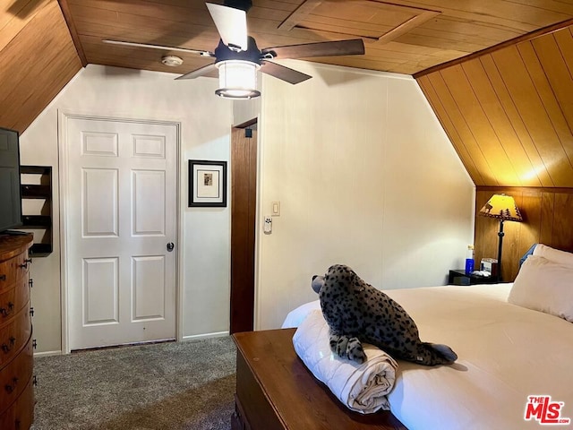 bedroom featuring ceiling fan, wooden ceiling, vaulted ceiling, and dark colored carpet