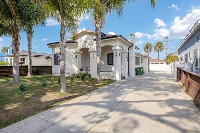 mediterranean / spanish-style home with a front lawn