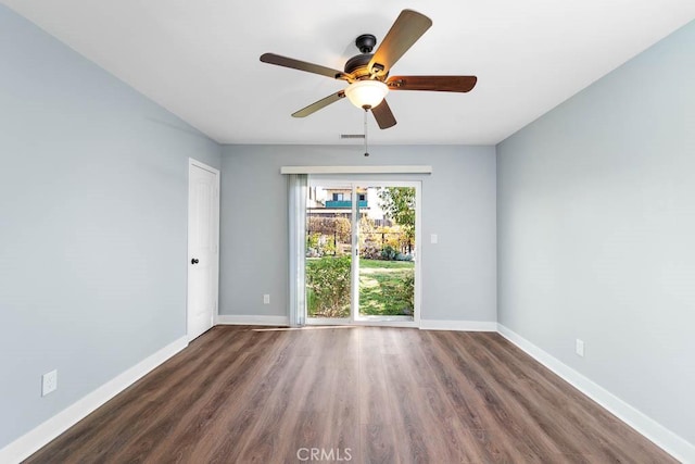 empty room with ceiling fan and dark hardwood / wood-style floors