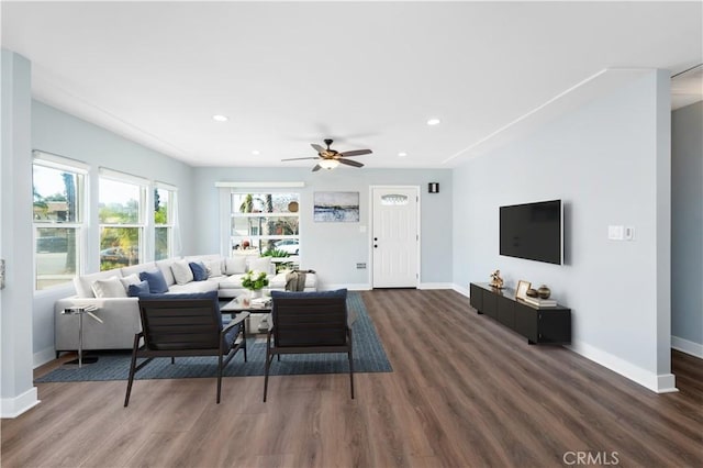 living room with ceiling fan and dark hardwood / wood-style floors