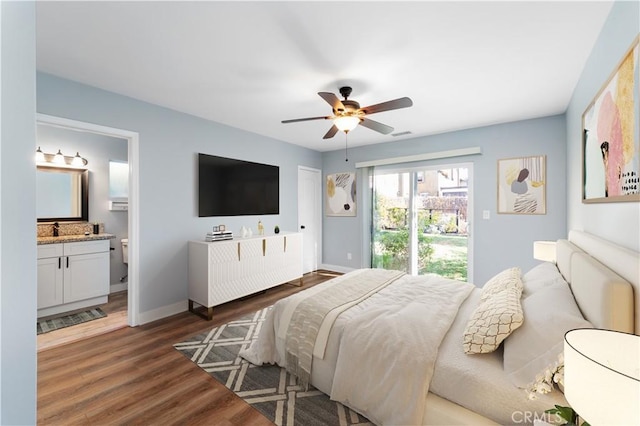 bedroom with ceiling fan, dark wood-type flooring, sink, and connected bathroom