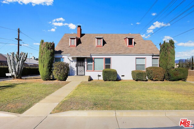 cape cod home with a front lawn