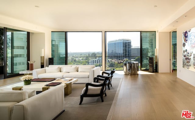 living room with wood-type flooring and a wall of windows