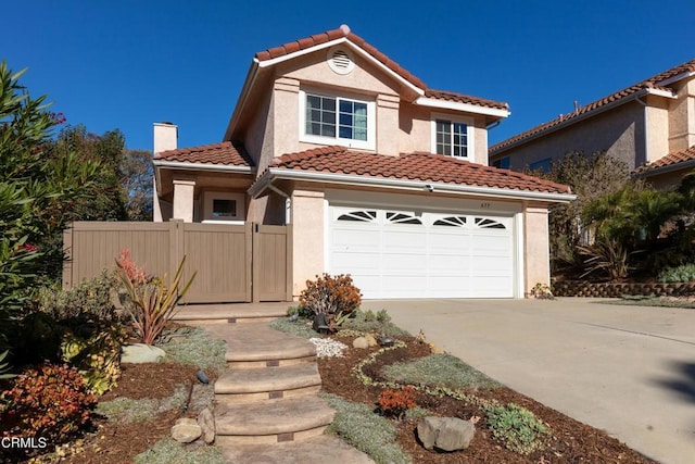 mediterranean / spanish-style house with a garage