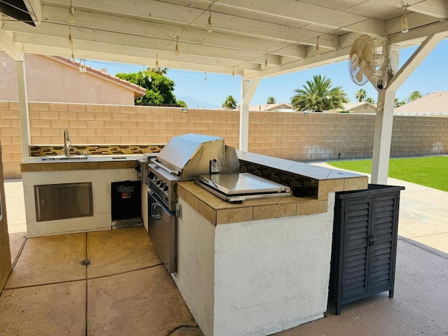 view of patio featuring sink, an outdoor kitchen, and area for grilling