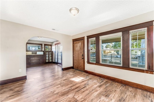 spare room with wood-type flooring and a textured ceiling