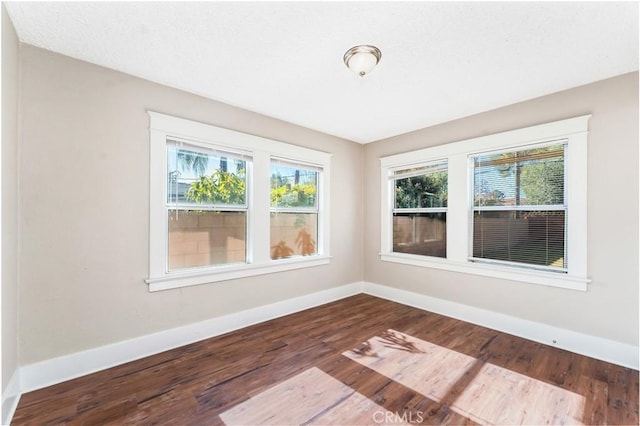 spare room with hardwood / wood-style flooring