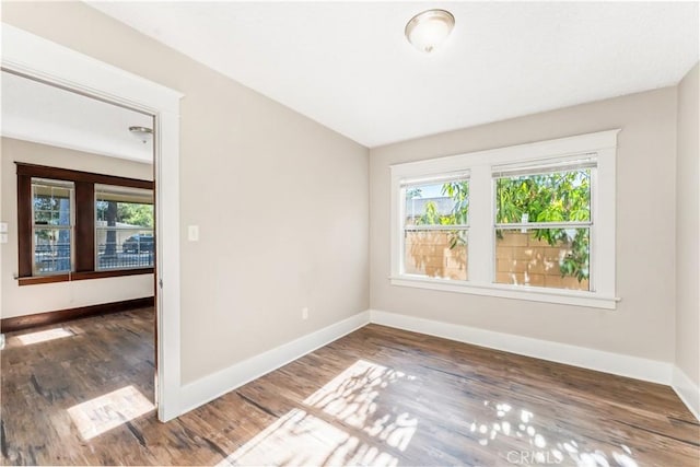 empty room featuring dark hardwood / wood-style flooring