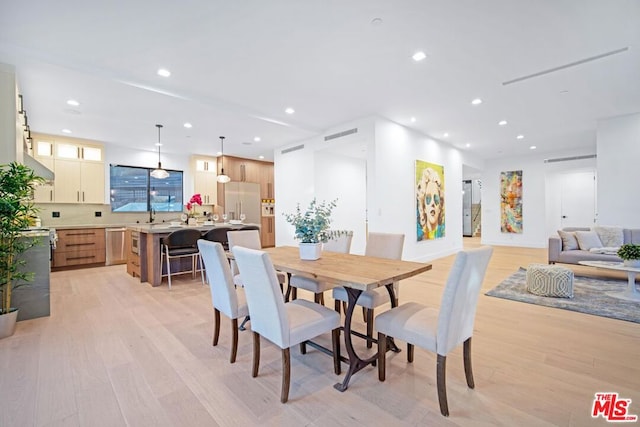 dining space with light wood-type flooring