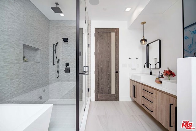 bathroom featuring vanity and separate shower and tub